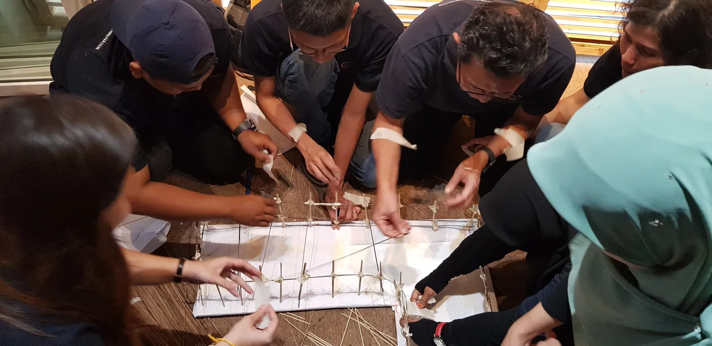 Tetra Exponus team constructing a model bridge in a team challenge