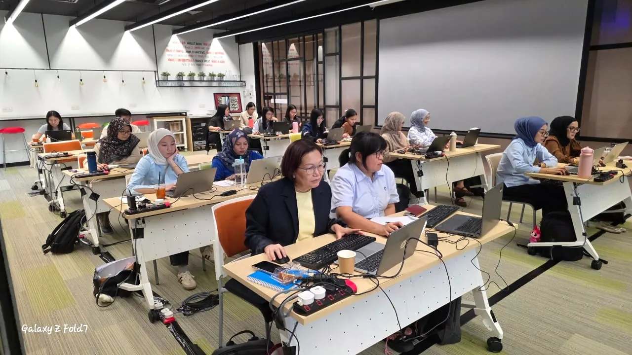 Training cohort on laptops during a workshop session